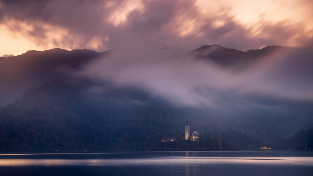 View across the beautiful Lake Bled, island church at sunset, Slovenia. Lake Bled is Slovenia's most popular tourist destination.