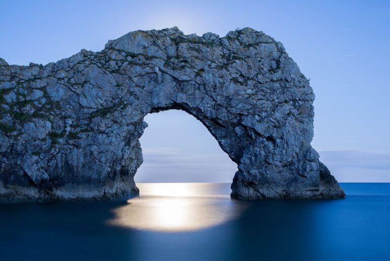 Durdle Door in the moonlight, Dorset, England. Captured late evening as the moonlight flooded through the rock's archway. Durdle door is one of the many stunning locations to visit on the Jurassic coast in southern England.