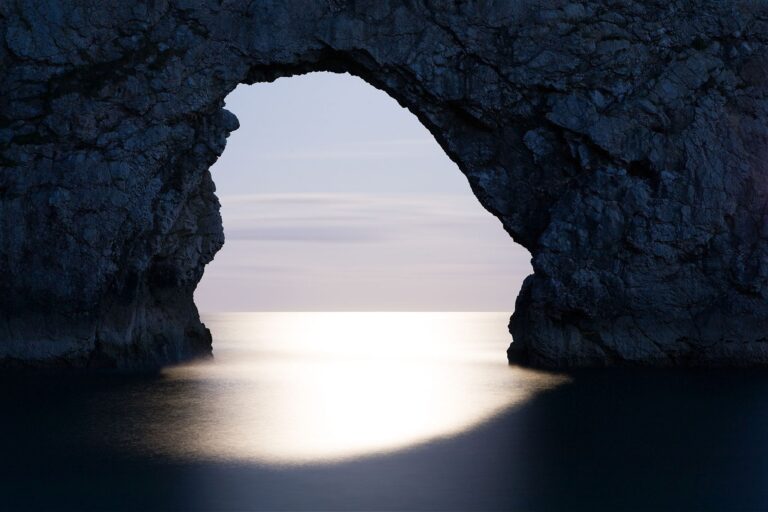 Durdle Door in the moonlight, Dorset, England. Captured late evening as the moonlight flooded through the rock's archway. Durdle door is one of the many stunning locations to visit on the Jurassic coast in southern England.