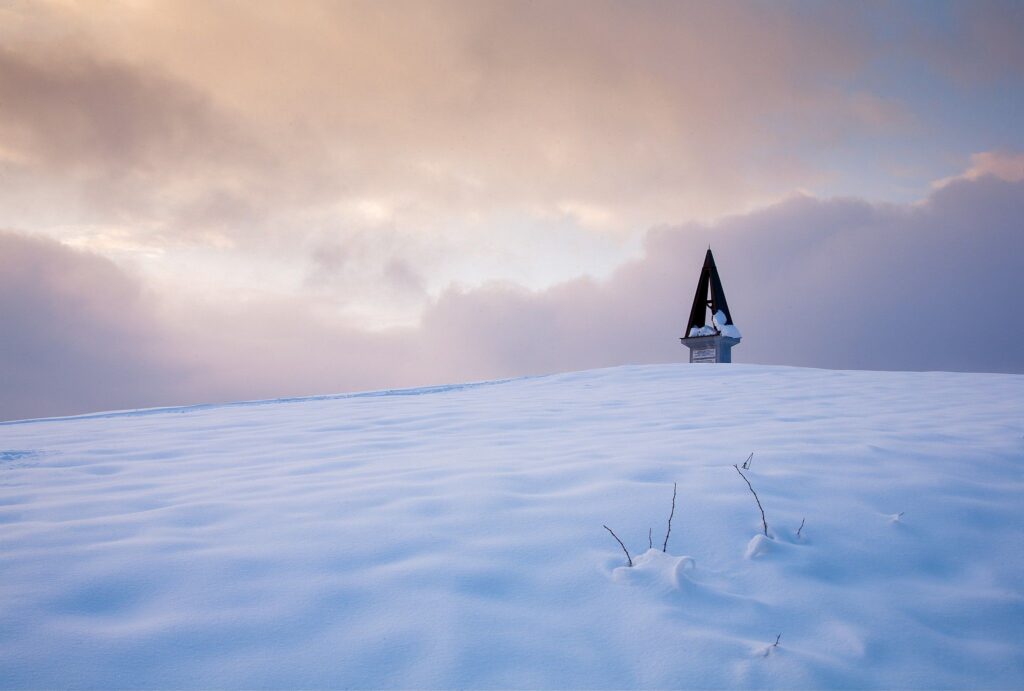 Winter view across a hill in prezganje in the Jance hills to the east of Ljubljana, Slovenia. The shrine is to Jesus Christ, built to commemorate the first visit of Pope John Paul the second to Slovenia in 1996.