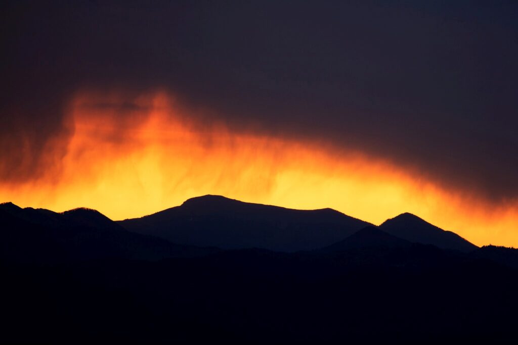 View of the sun setting against a stormy sky over the western mountains of Slovenia. This image was taken from a hill in Tunjice, near Kamnik, where you get a unobstructed view right across to the west.