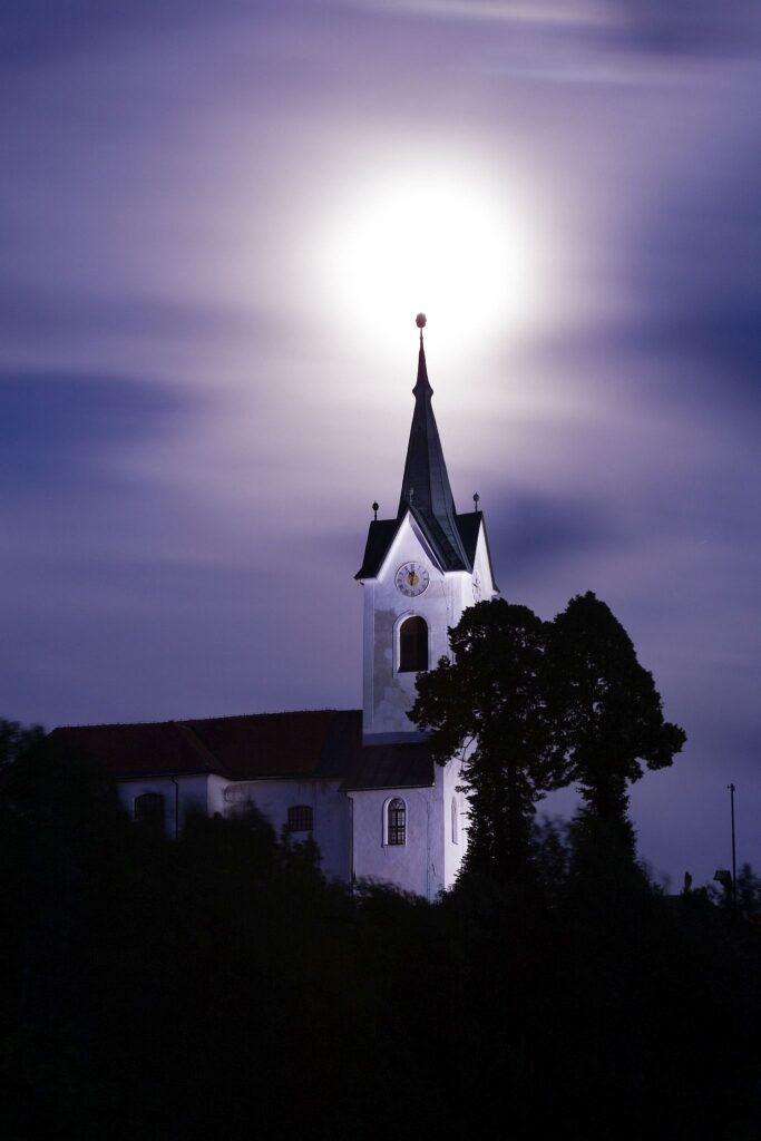 The 2013 supermoon rises over the spire of the church of Saint Marjeta (Sveta Marjeta) in Prezganje in the Jance hills to the east of Ljubljana, Slovenia. This was shot on the evening of June 22nd, the night before totality and the moon was approximately 98% full.