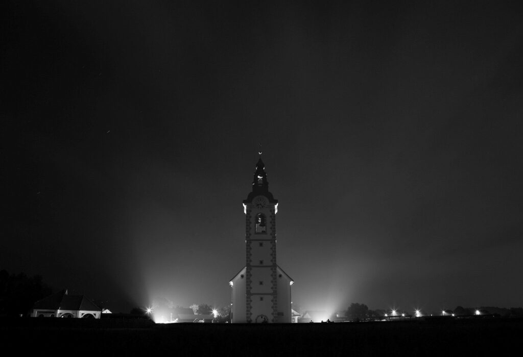 Black and white image of the the church of saint John (Sveti Janez) at night, Brnik, Slovenia.