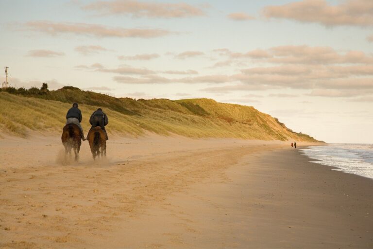 Horse riders on Blackwater beach, County Wexford, Ireland.