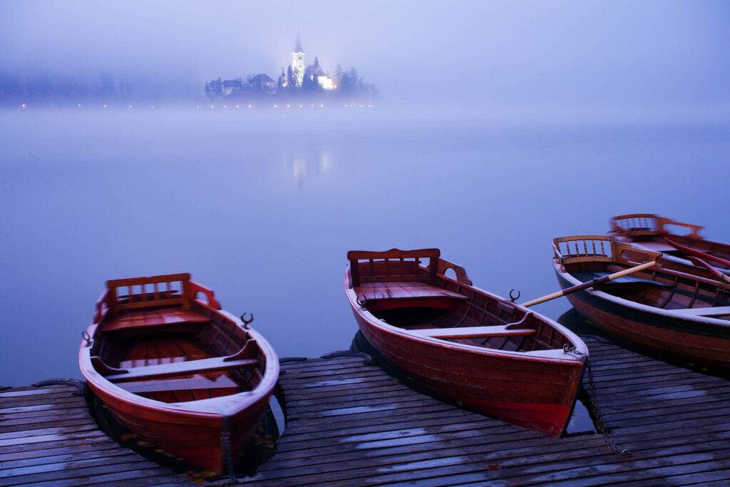 The famous Island church enshrouded in an icy mist and frost over Lake Bled.