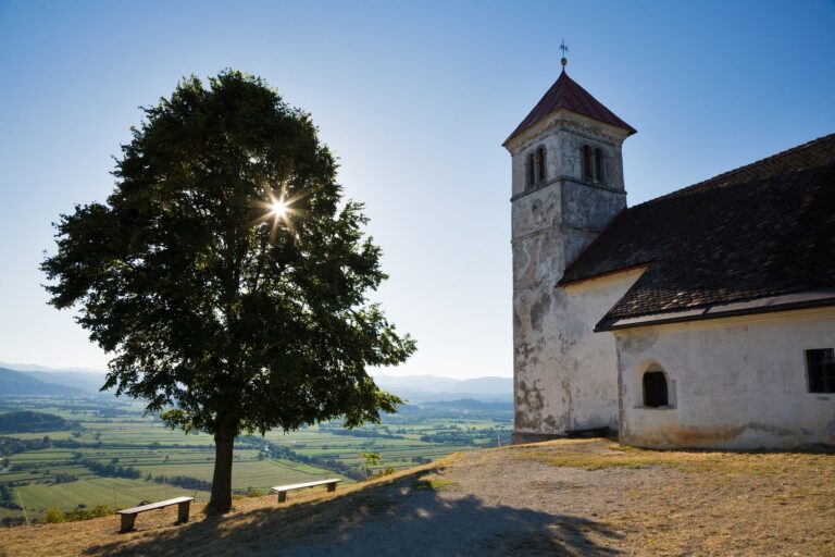 Soft light falls over the church of Saint Anna (Sveta Ana) as the sun falls down behind a nearby tree. Sveta Ana is perched upon an exposed hill overlooking the Ljubljansko Barje (Ljubljana marsh) near the village of Preserje. The views from this hill are spectacular and many locals seem to come here for the evening.