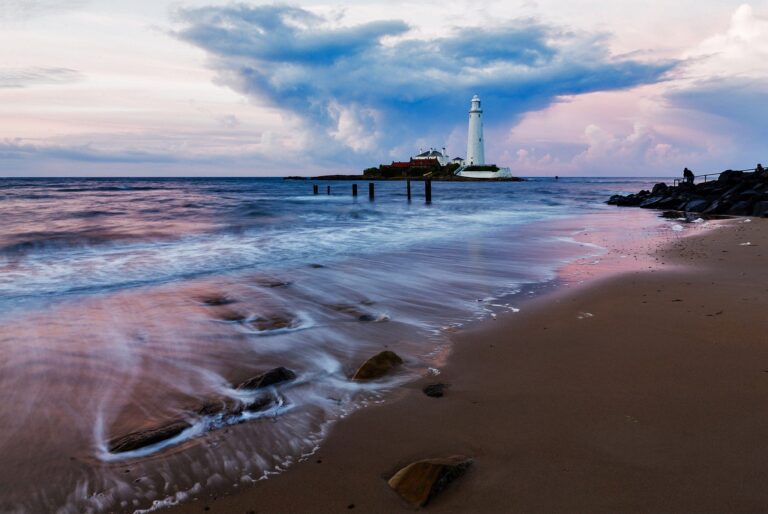 Saint Mary's Lighthouse on Saint Mary's Island, situated north of Whitley Bay, Tyne and Wear, North East England. Seen at sunset from the beach beside the causeway that runs out to the island. Whitley Bay is situated just north of Newcastle.