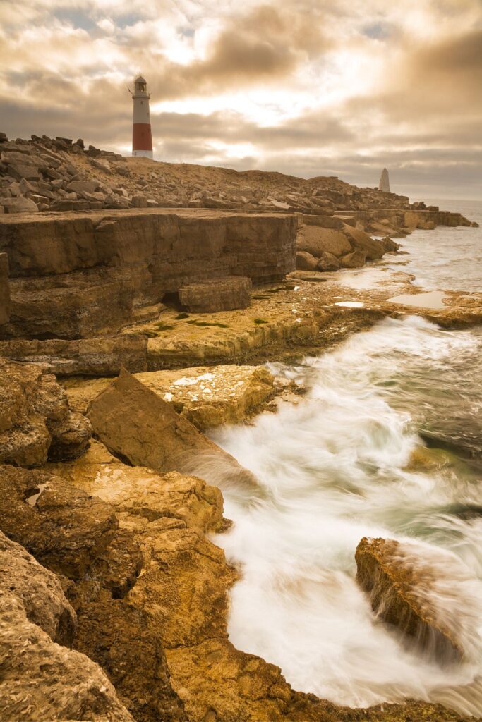 Lighthouse at Portland Bill in the early morning sun, near Weymouth, Jurassic Coast, Dorset, England.