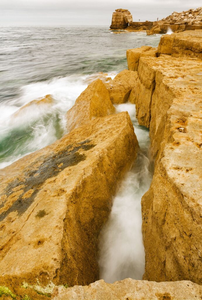 Waves crashing over Pulpit rock and the promontory at Portland Bill, near Weymouth, Jurassic Coast, Dorset, England. Pulpit Rock is an artificial stack that was left behind after quarrymen dug away a natural arch in 1870s. The Jurassic Coast is a stretch of coastline with a geology that dates back 185 million years, and is a UNESCO World Heritage Site.