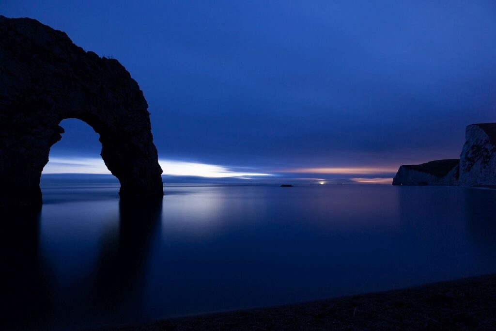 Close up of Durdle Door as the last wisp of light disappears over the horizon at dusk, Dorset, England. Durdle door is one of the many stunning locations to visit on the Jurassic coast in southern England.