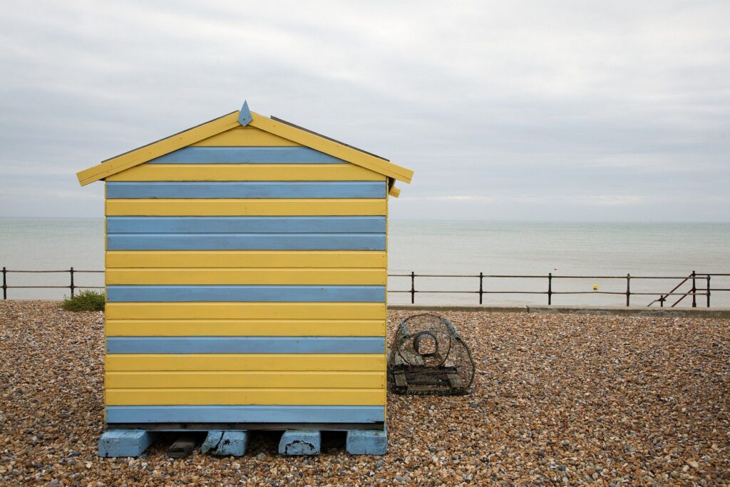 Colourful beach hut in the morning at Kingsdown beach, near the famous White Cliffs of Dover, Kent, England. These wooden beach huts are an iconic piece of the English coast