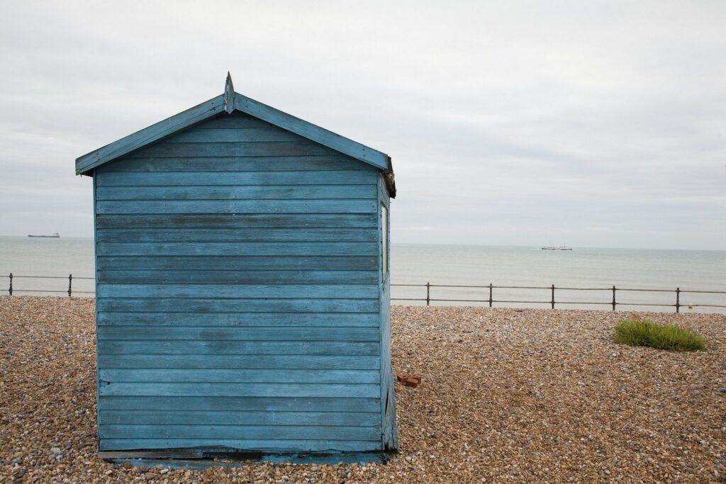 Blue beach hut in the morning at Kingsdown beach, near the famous White Cliffs of Dover, Kent, England. These wooden beach huts are an iconic piece of the English coast