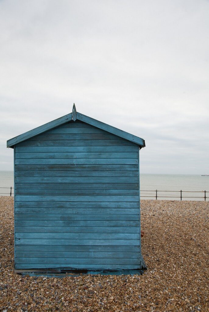 Blue beach hut in the morning at Kingsdown beach, near the famous White Cliffs of Dover, Kent, England. These wooden beach huts are an iconic piece of the English coast