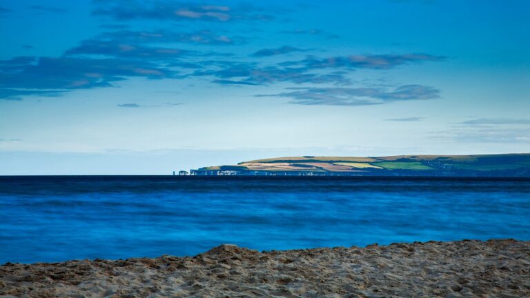 View of Handfast Point and Old Harry Rocks, on the Isle of Purbeck, from Bournemouth beach, Dorset, England.