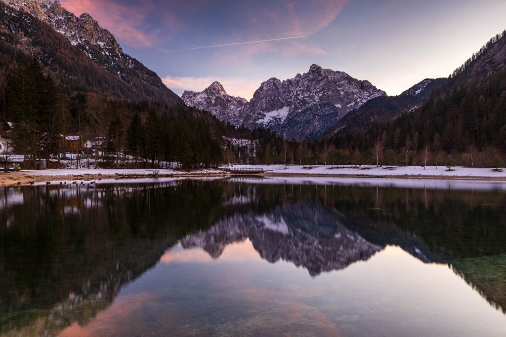 Sunset over the Julian Alps seen across Lake Jasna in winter, near Kranjska Gora, Slovenia