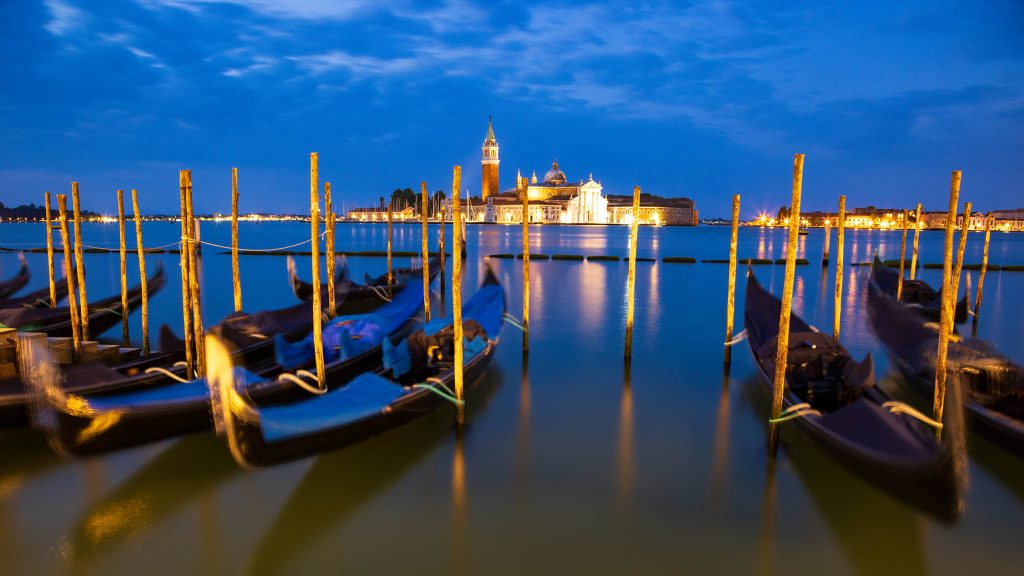 Gondolas at dawn with the Church of San Giorgio Maggiore over the Grand Canal in Venice, Italy.