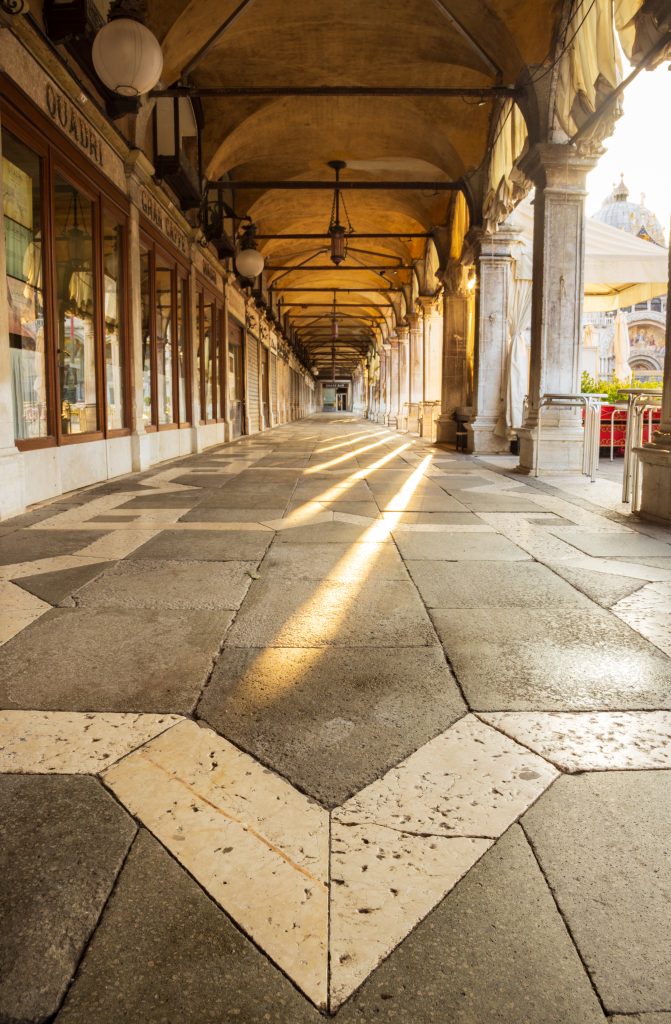 Morning light in the covered walkway at Piazza San Marco in Venice, Italy