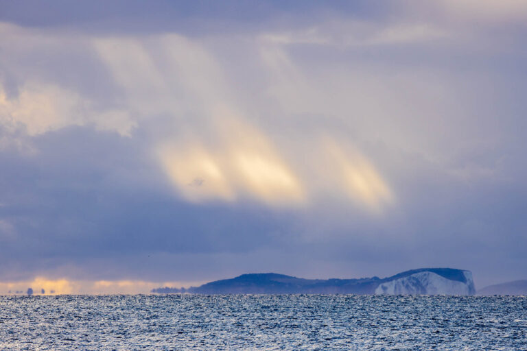 Morning light over the Isle of Wight, seen from Swanage seafront in Dorset, England.