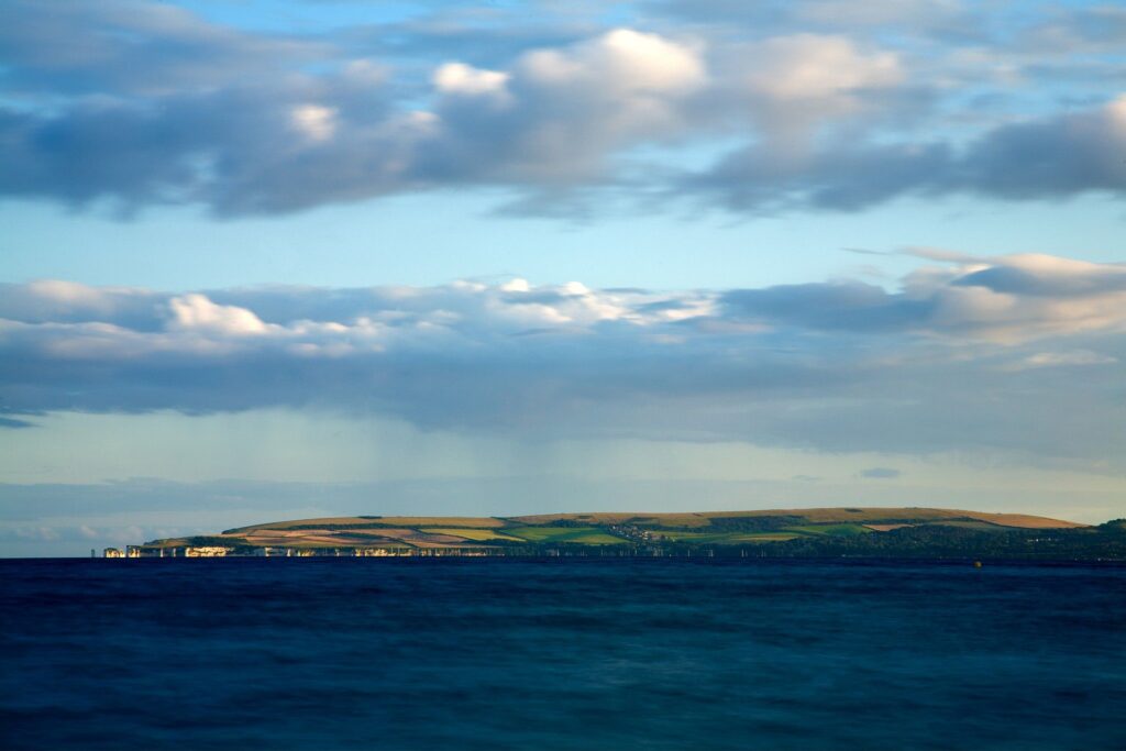 View of Handfast Point and Old Harry Rocks, on the Isle of Purbeck, from Bournemouth beach, Dorset, England.