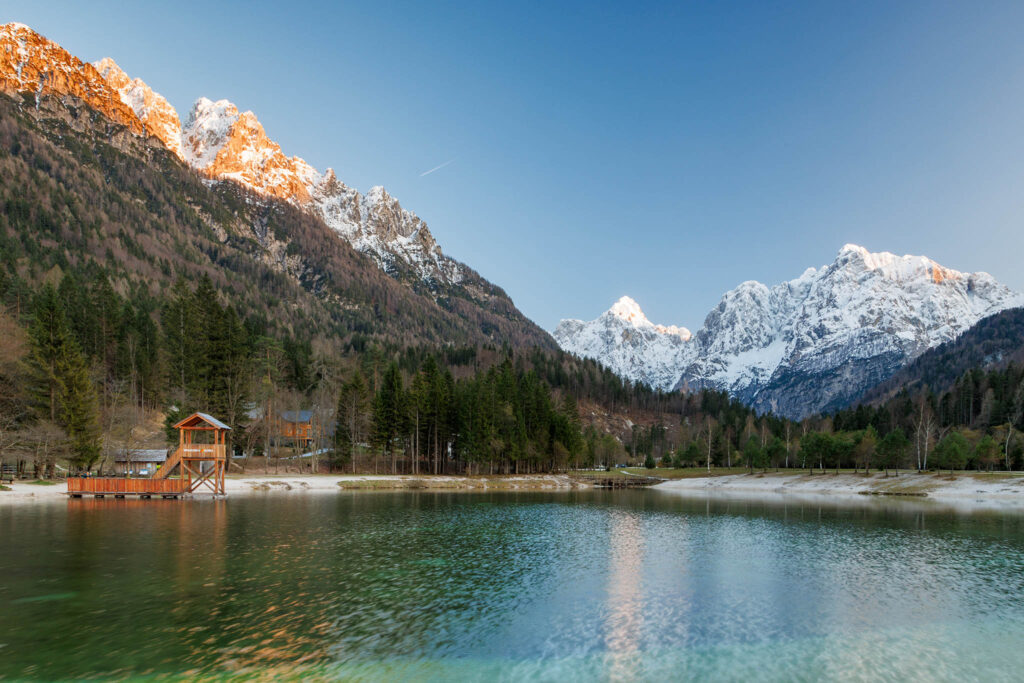 Sundown over the Julian Alps seen across Lake Jasna, near Kranjska Gora, Slovenia