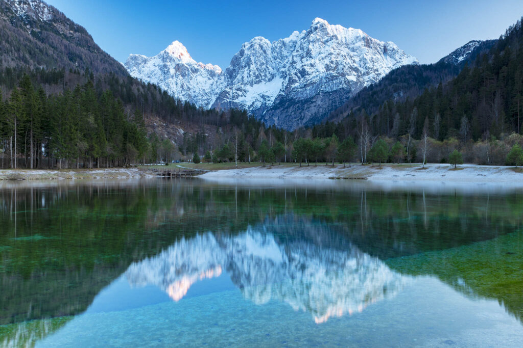 The Julian Alps seen across Lake Jasna near Kranjska Gora, Slovenia