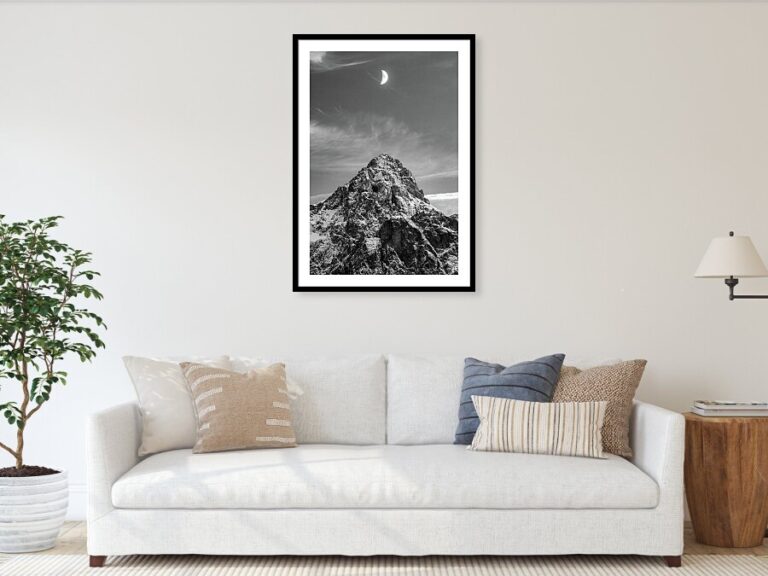 Quarter moon rising over Mount Razor in the Julian Alps mountains of Slovenia. Seen from Lake Jasna near Kranjska Gora.
